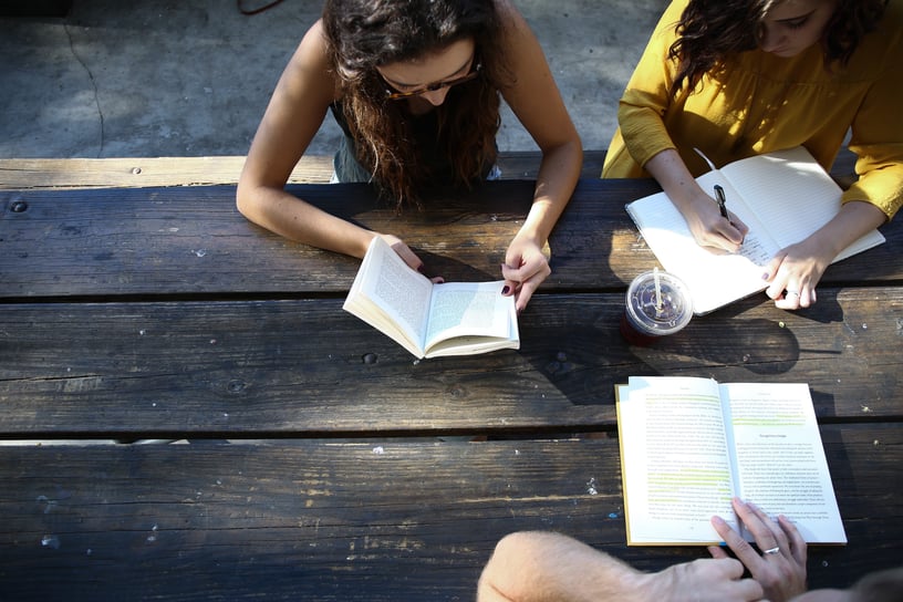 People-At-Table-Working-In-Books.jpeg